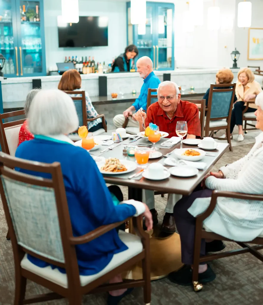 A group of senior adults enjoy cocktails and dinner together