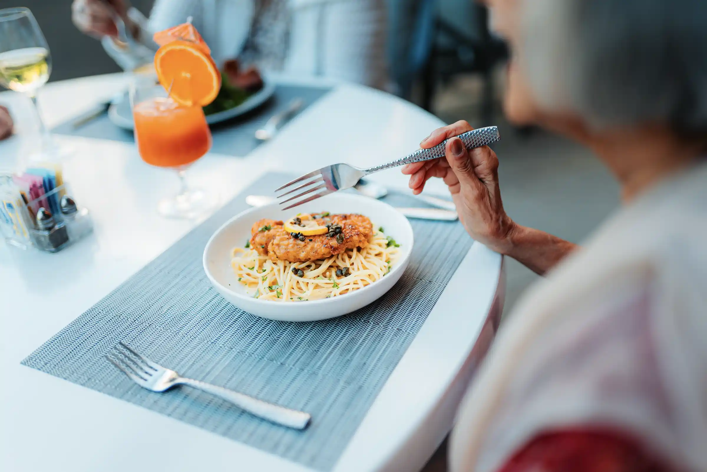 Woman eating a bowl of pasta