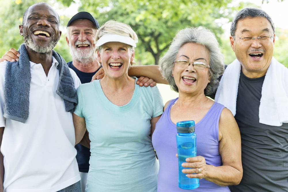 Group of seniors outside laughing and exercising 