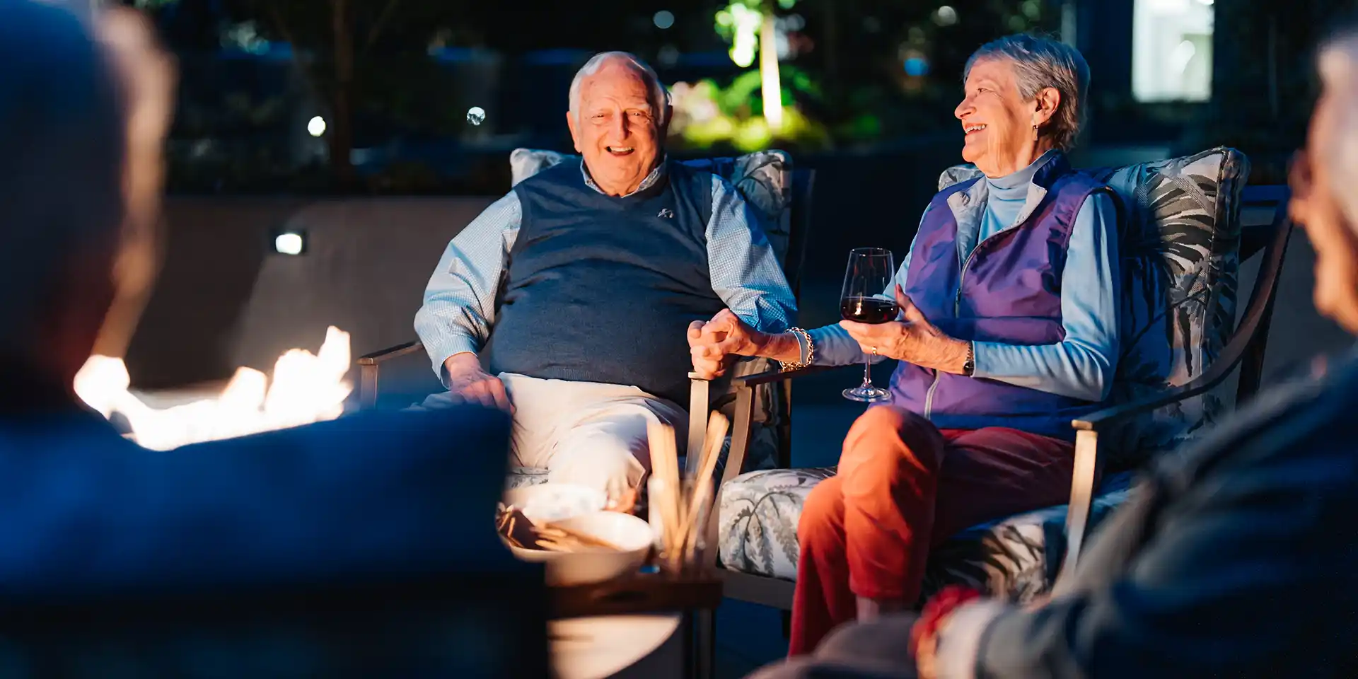 Canterbury Court residents sitting around the fire pit on the activities deck.